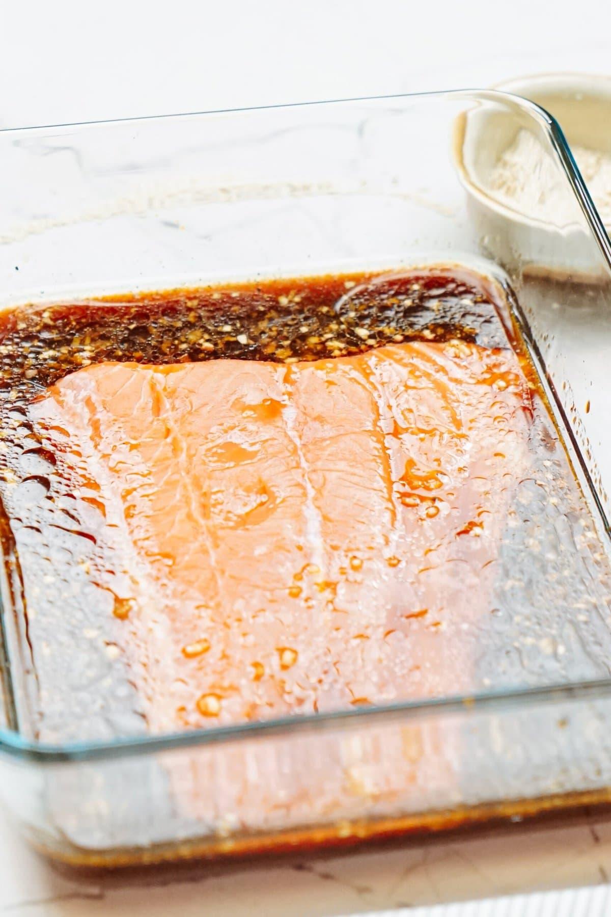 Salmon in a baking dish with a delicious sauce.
