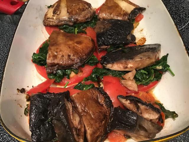 vegan entree with portobello mushrooms Plant-based mushroom stacks with spinach and tomato