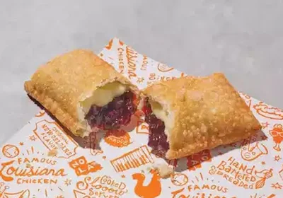 Popeyes Blueberry Lemon Cream Cheese Fried Pie broken in two.