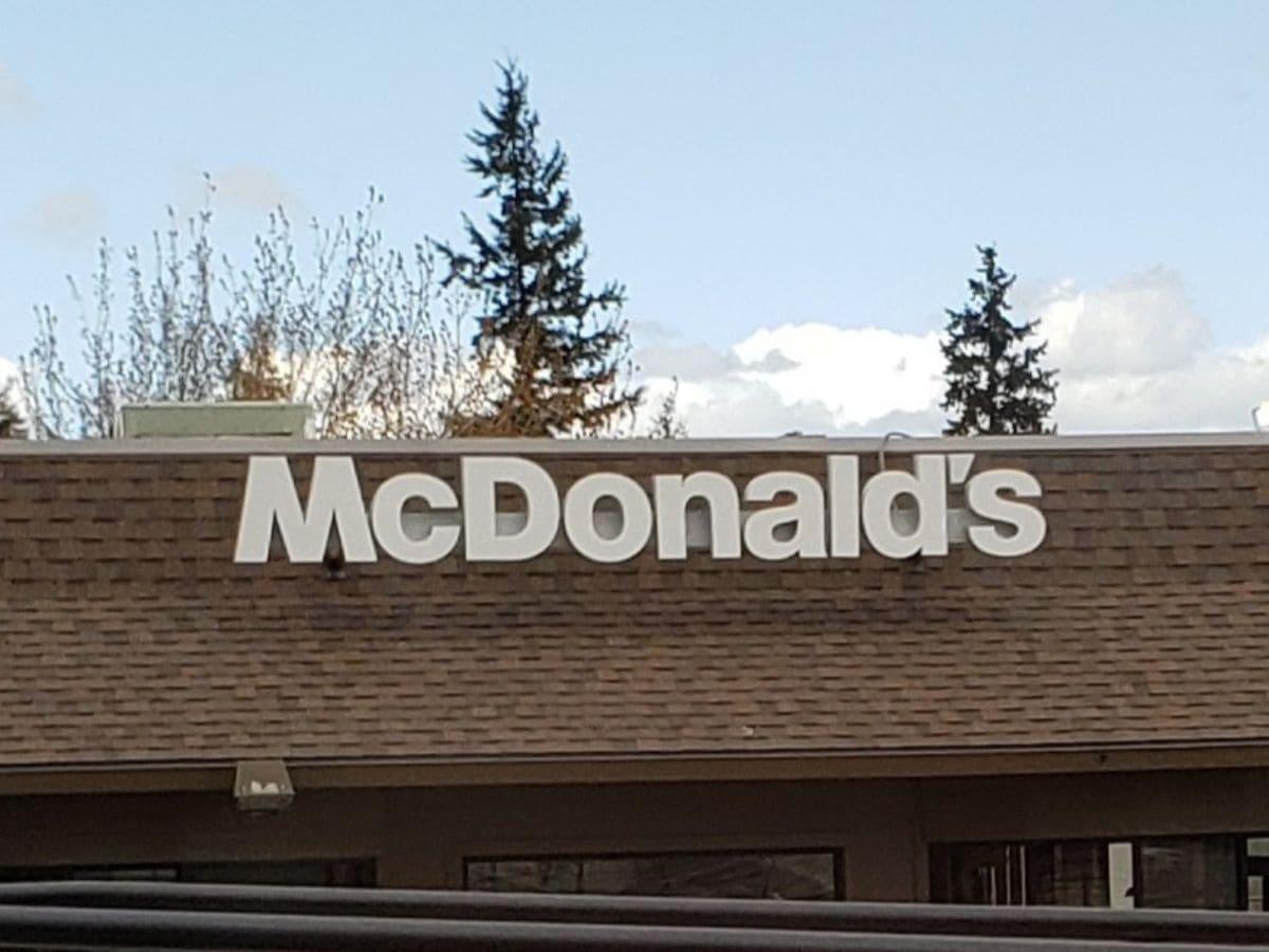 A cheap fast food sign is on top of a building.