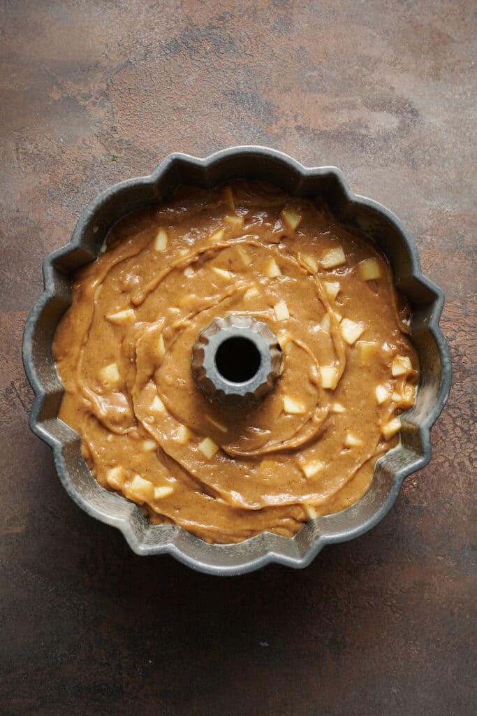 Apple Bundt cake batter in Bundt cake pan.