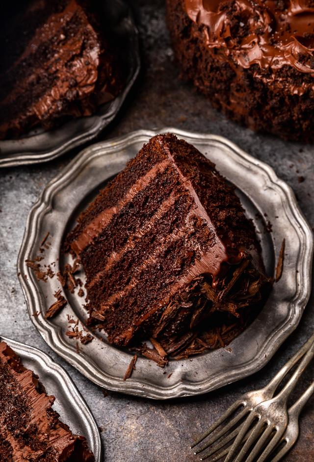 Slice of devil's food cake on a silver plate.