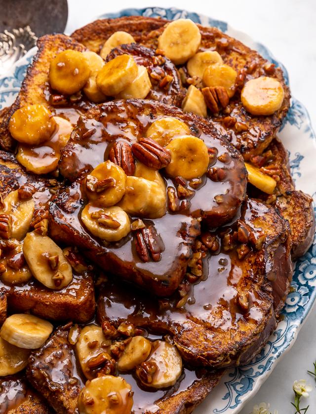 This Easy Bananas Foster French Toast is one of our favorite breakfast recipes! Crispy slices of buttery brioche are topped with a delicious homemade bananas foster sauce made from dark rum, butter, brown sugar, heavy cream, and crunchy pecans. Delicious on it's on, but devilishly good with whipped cream or vanilla ice cream!