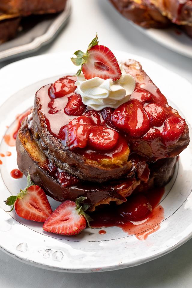 Strawberries and Cream French Toast features buttery slices of brioche bread, fresh strawberries, and whipped cream! A fancy restaurant-quality recipe that's perfect for Easter, Mother's Day, or a bridal shower brunch! This recipe can easily be doubled if you're serving a large crowd!