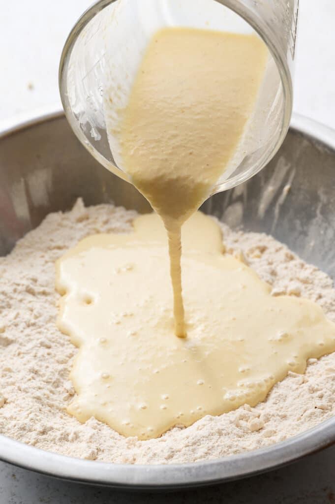 Pouring the wet ingredients into the scone dough.