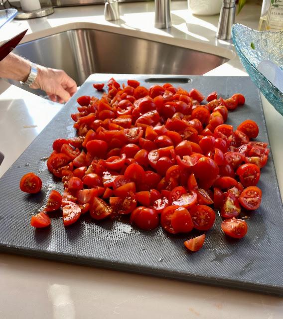 chopped cherry tomatoes on cutting board