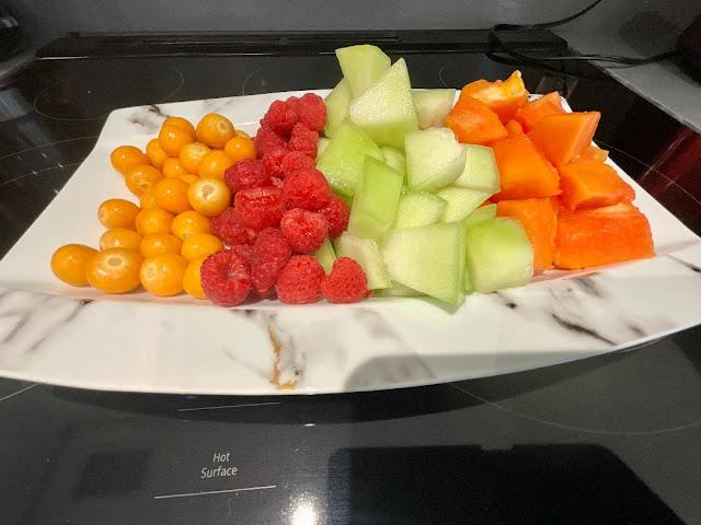 platter with raspberries, cantaloupe, honeydew and yellow sun grapes