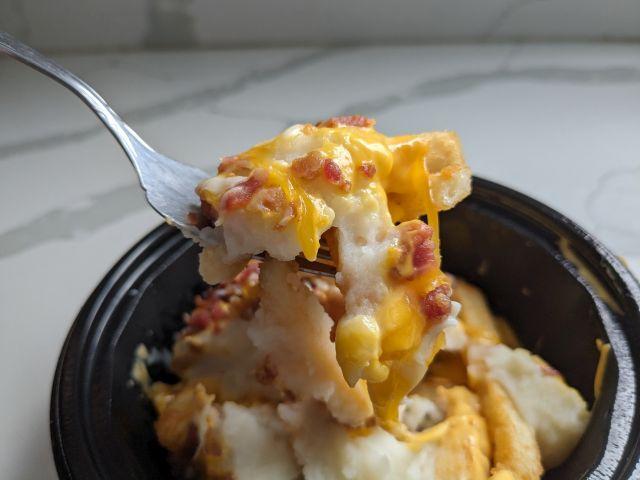 A forkful of KFC's Smash'd Potato Bowl.