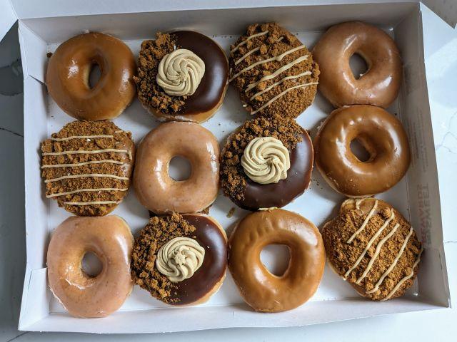 A dozen box of Krispy Kreme's 2024 Biscoff Cookie Butter Donuts.