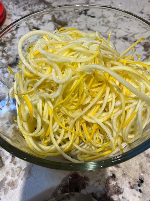 yellow zucchini spiralized in a glass bowl