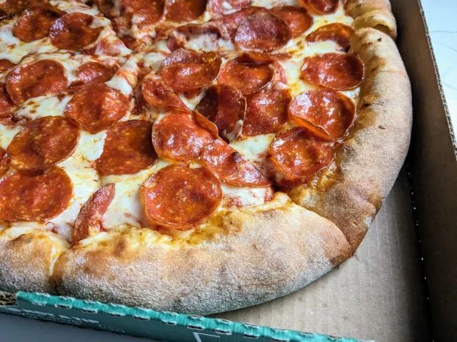 Close up of Papa Johns Cheesy Calzone Epic Stuffed Crust Pizza.