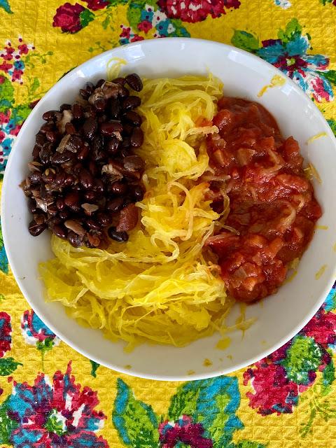 a bowl with black beans, spaghetti squash, and salsa