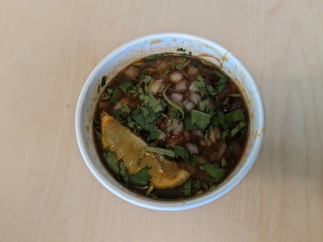 Top-down view of Del Taco's Birria Ramen