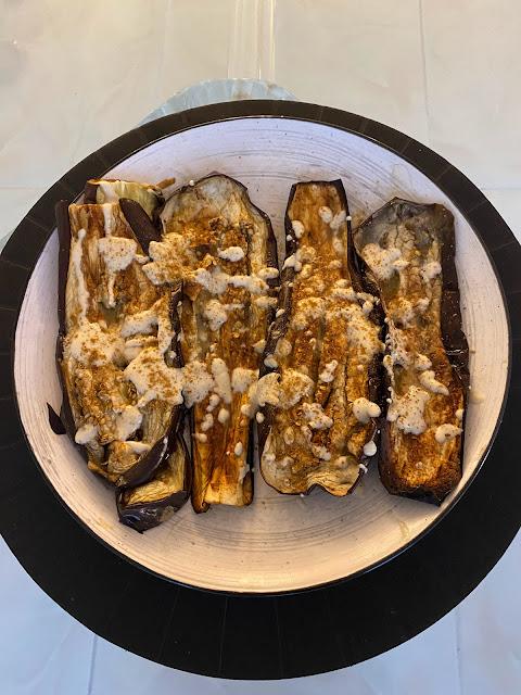 eggplant slices topped with tahini sauce, vegan