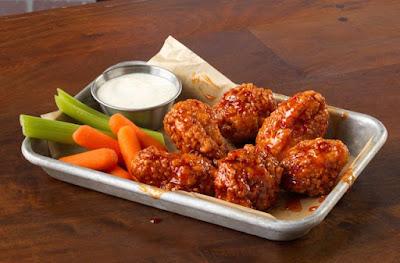 A tray of six Buffalo Wild Wings' chicken wings with celery, carrots, and ranch.