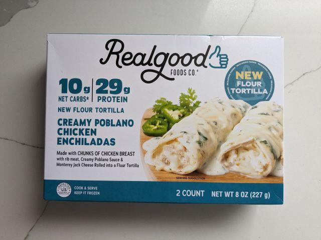 The packaging for Cross-section of Real Good Foods Creamy Poblano Chicken Enchiladas.