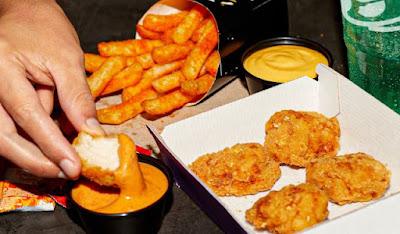 Taco Bell Crispy Chicken Nuggets with sauce and Nacho Fries.