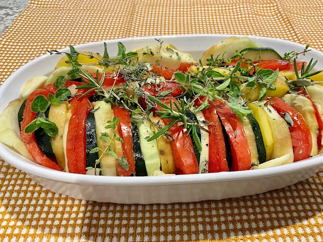 tien of layered vegetables in a casserole dish, vegan