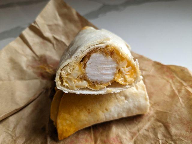 The cross section of a Spicy Mac & Cheese KFC Wrap.