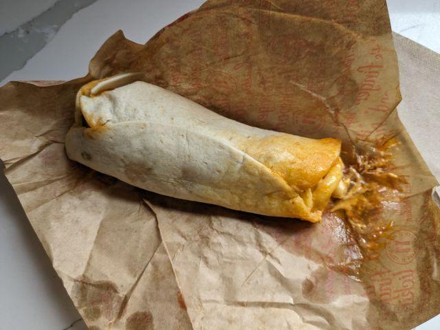 A top-down view of a Spicy Mac & Cheese KFC Wrap on its side.