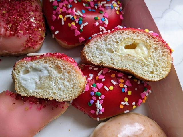 Cross-section of Krispy Kreme's You're Berry Sweet Donut and You Color My World Donut.