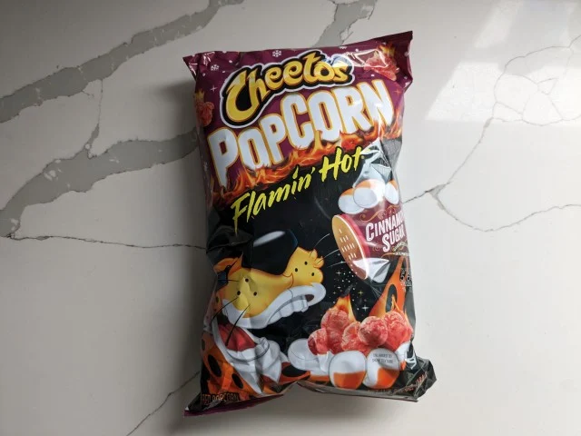 A bag of Cinnamon Sugar Flamin' Hot Cheetos Popcorn.