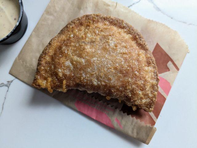 The crispy-bubbly side of Taco Bell's Cheesy Chicken Crispanada.