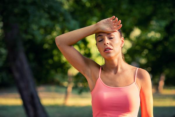 Woman Tired After Workout Wiping off Sweat | Dizzy After Workout