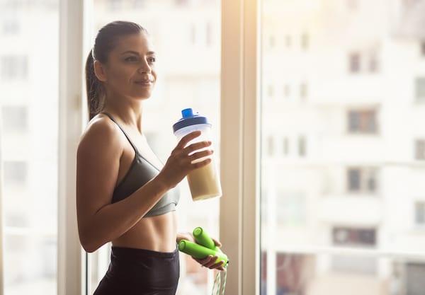 Woman Drinks Protein Shake By Window | Pea Protein vs Soy Protein