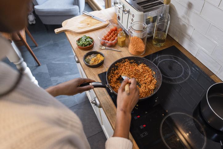 Over the Shoulder Shot of Person Cooking Vegan Meal with Lentils | Vegan Facts