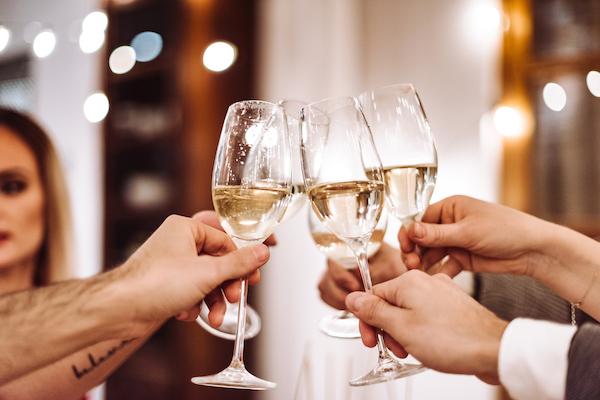 Close Up Shot of People Cheering with Glasses of Champagne | Dry January