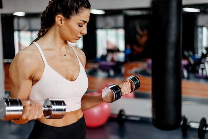 Woman Curls Light Dumbbells | Deload Week