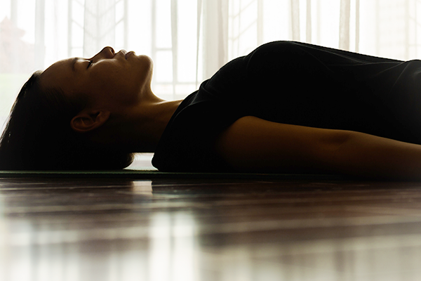 Woman Meditates While Laying on Floor | How Long Should You Meditate