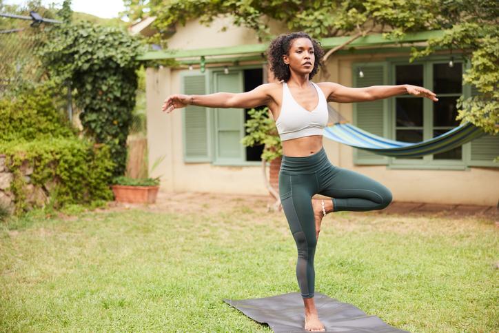 Woman Does Tree Pose on One Leg | Benefits of Walking Backwards