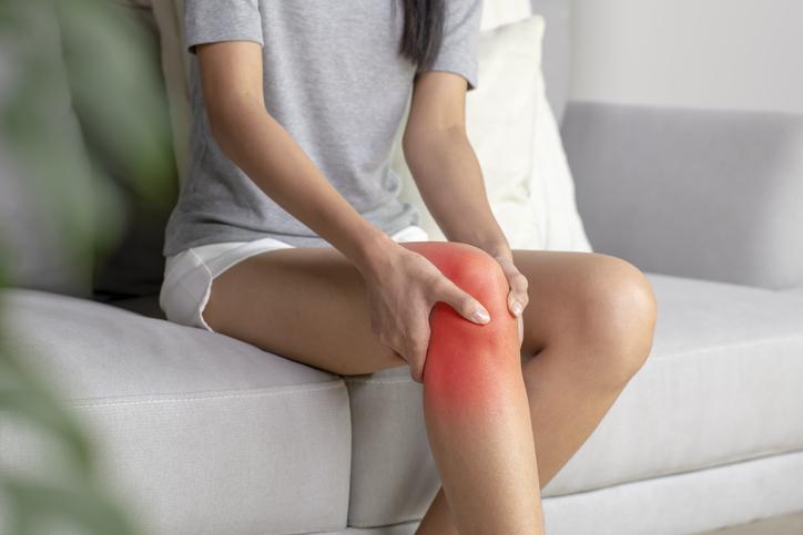 Woman Holds Knee in Pain | Benefits of Walking Backwards