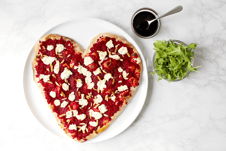 heart-shaped pizza with toppings