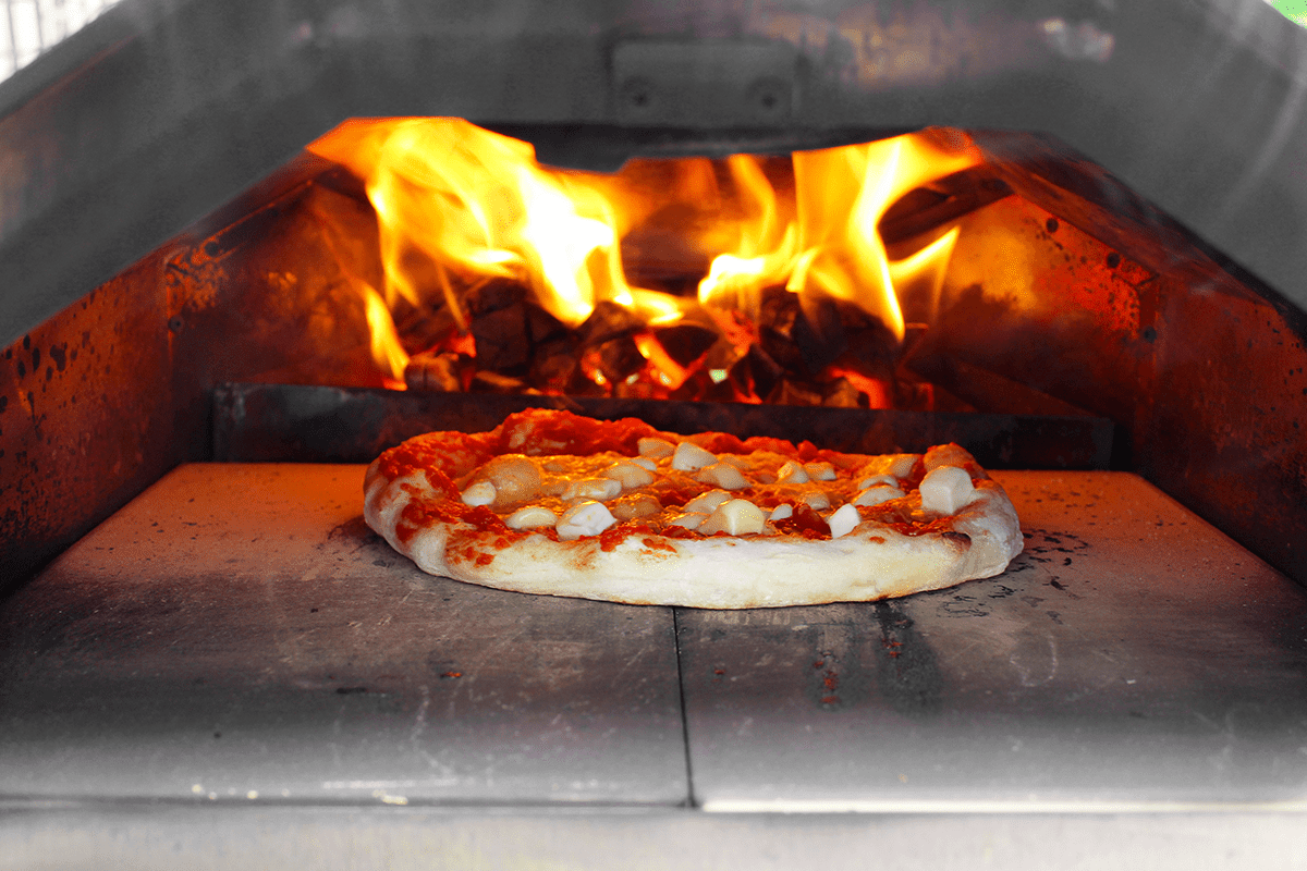 pizza cooking in hot pizza oven