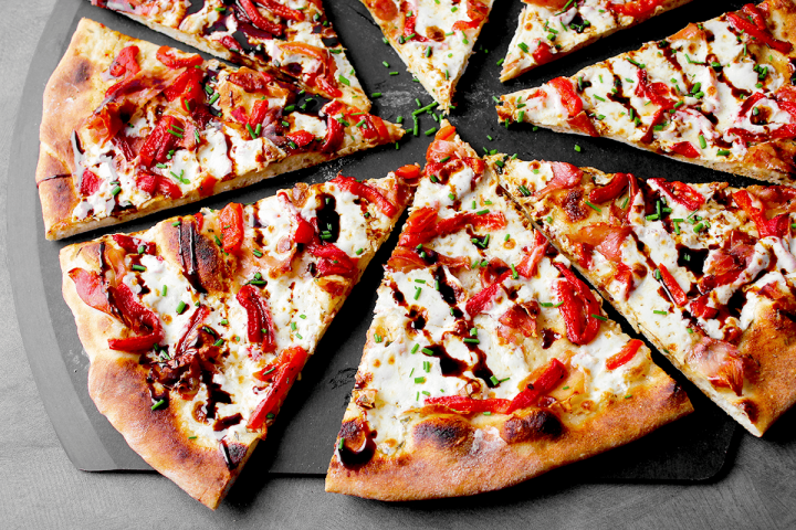 prosciutto pizza slices on peel