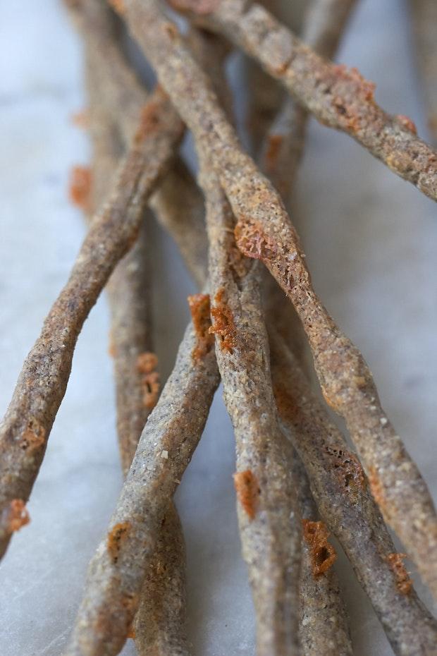 cheese straws arranged in a pile