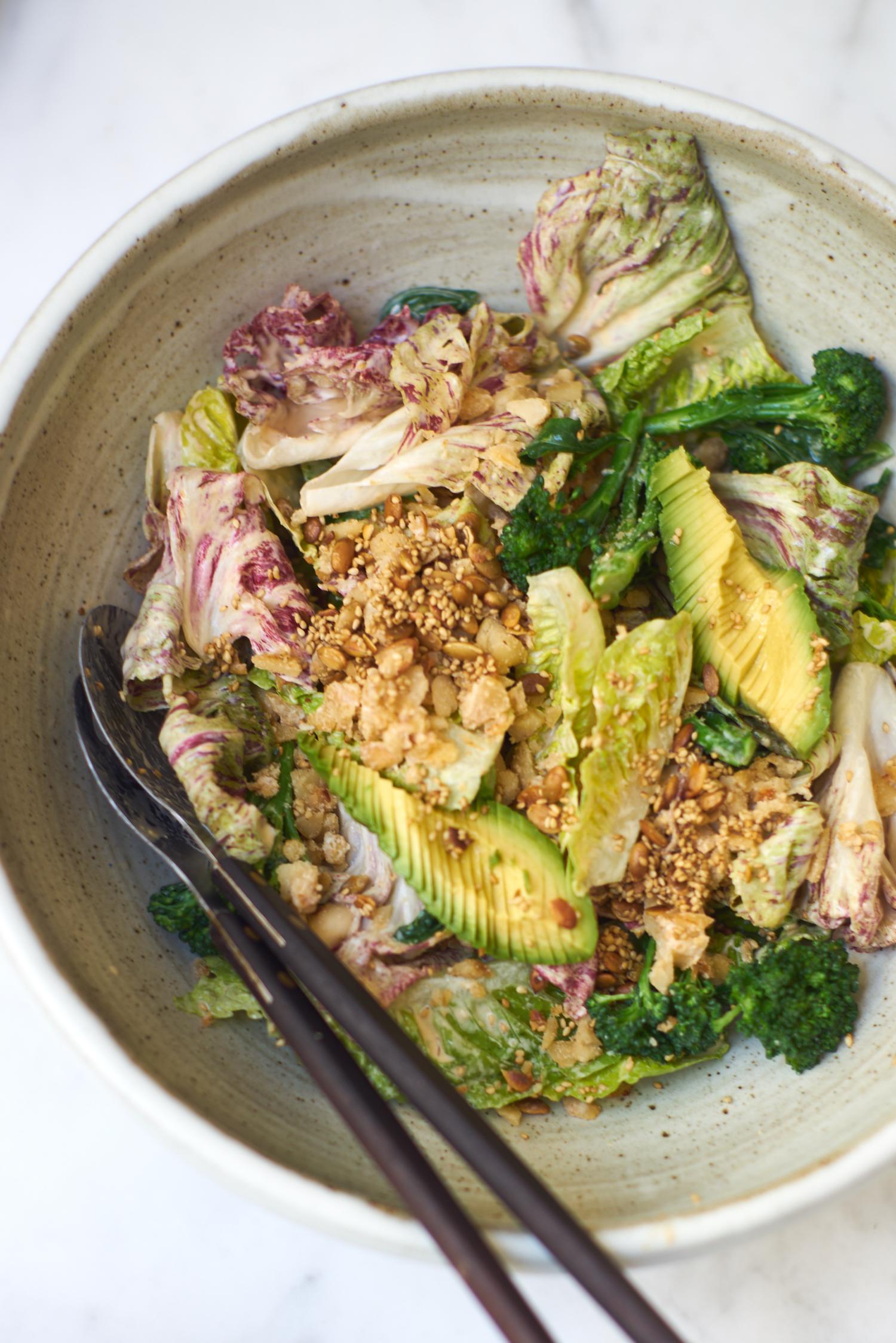 Anna Jones california salad with beans, miso, avocado in big ceramic salad bowl