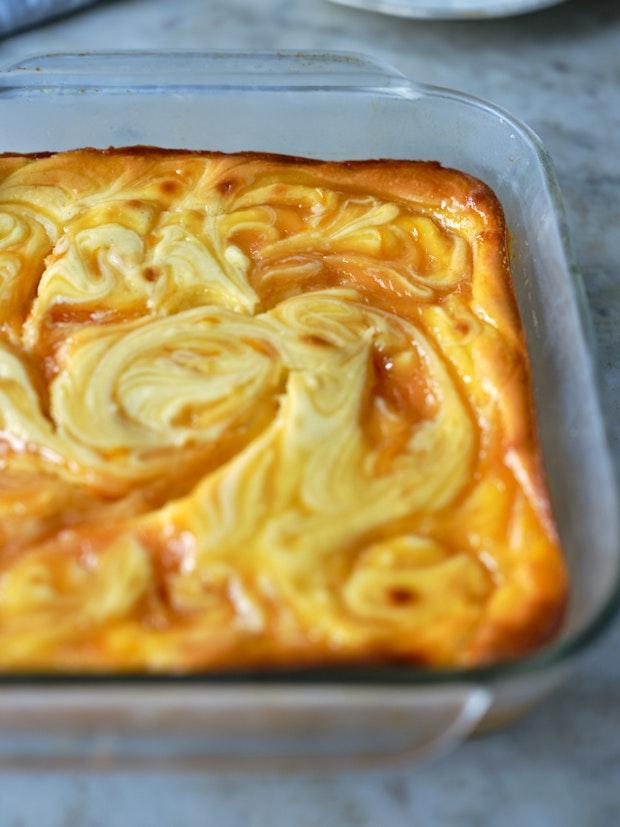 cheesecake bars baked in a glass baking dish