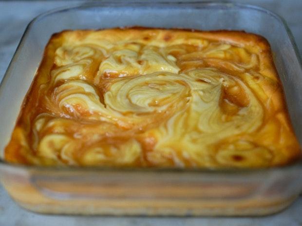 cheesecake bars baked in a glass baking dish