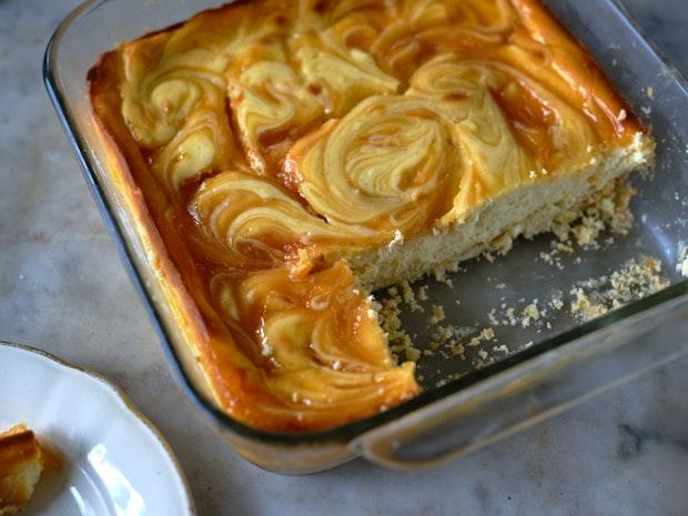 cheesecake bars baked in a glass baking dish