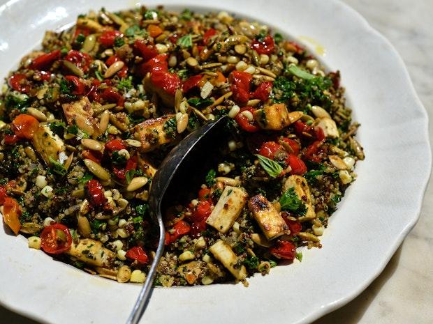 Big plate of quinoa with tomatoes, pesto, and pepitas