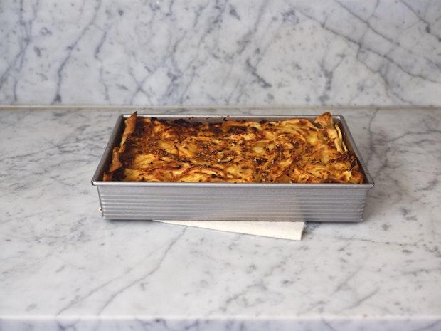 Mushroom Lasagna in pan just after baking on cooling on a counter