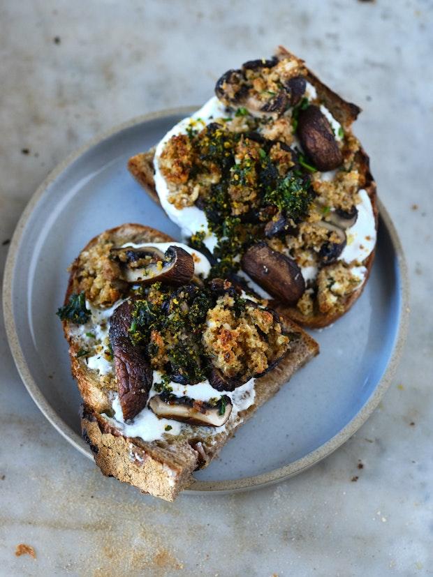 stuffed mushrooms sliced and arranged on an open-faced mushroom sandwich with ricotta