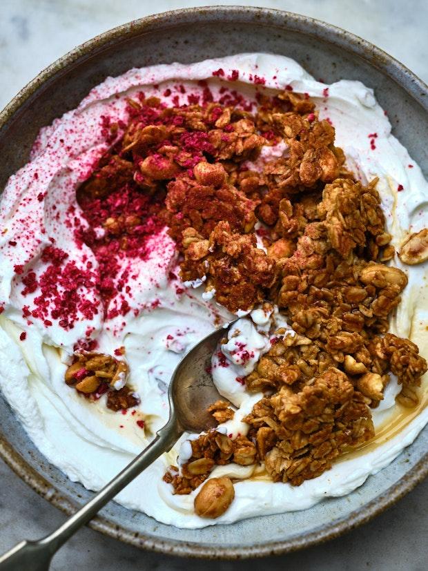 peanut butter granola topping yogurt in a ceramic bowl