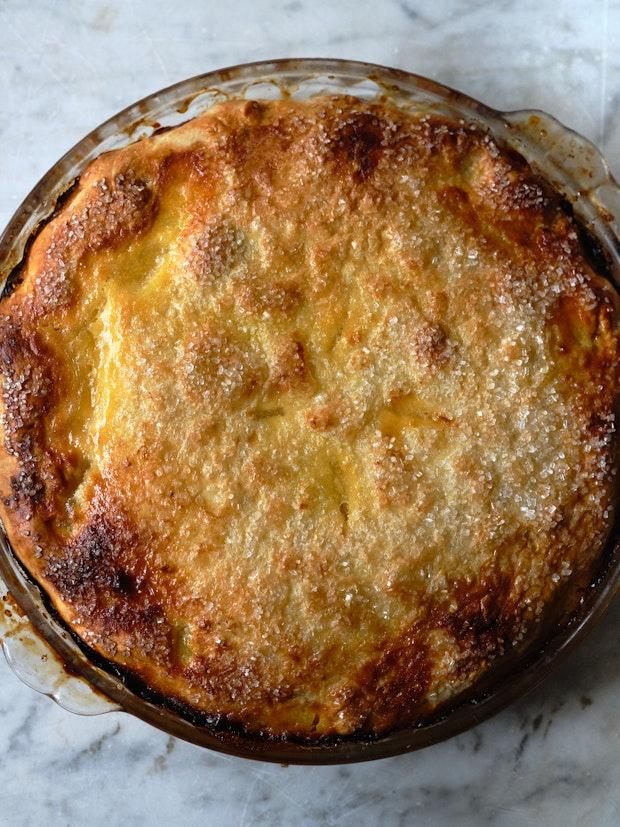 all-butter pie crust in a glass baking dish with edge turned under