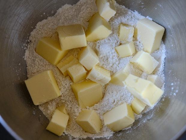 cubes of butter on a pie of flour in a bowl