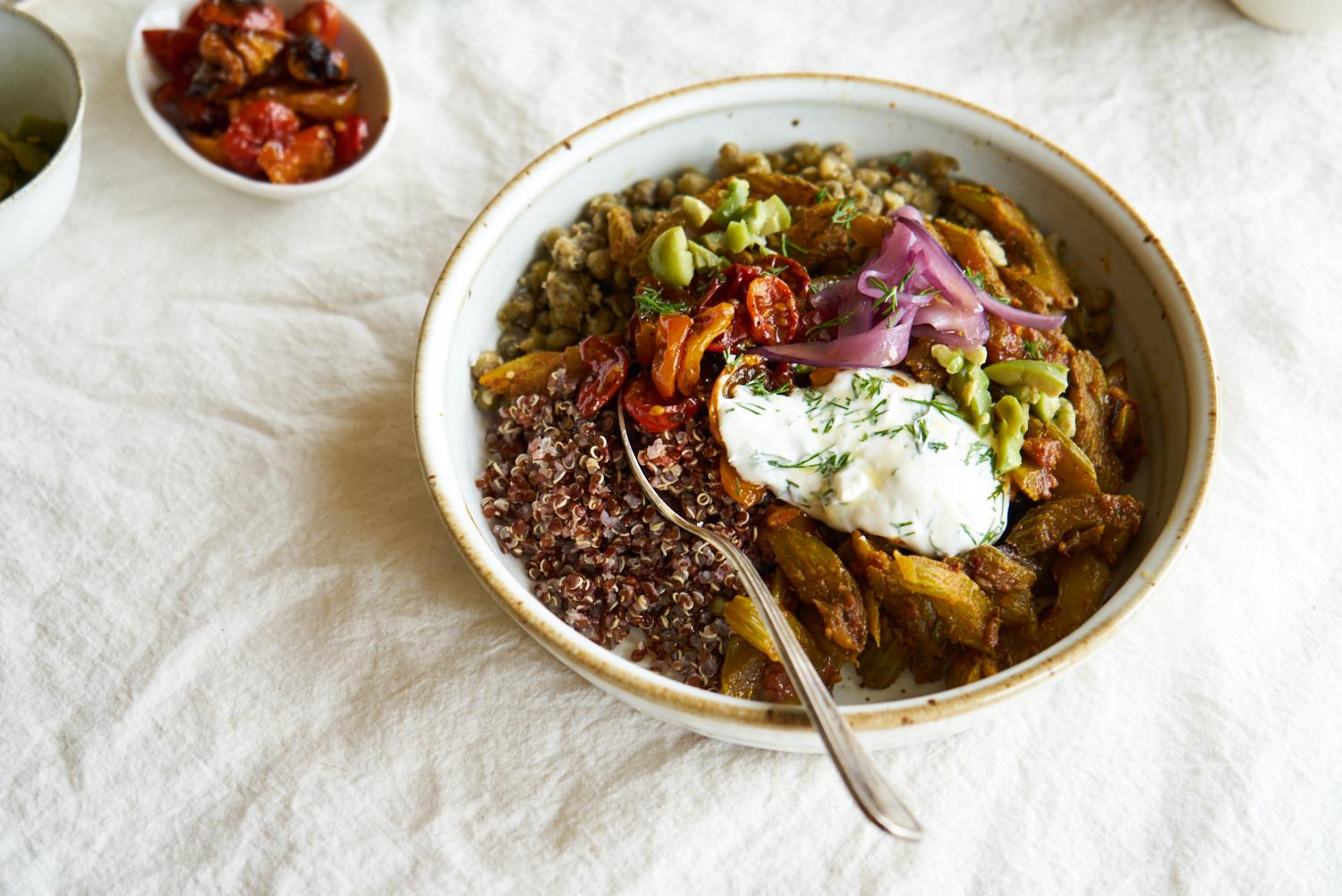 quinoa power bowl topped with tomatoes, yogurt, onions